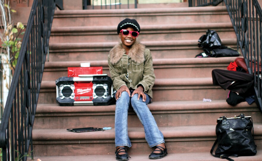 "When I walked by," Stanton writes in his book, "she was really moving to the music — hands up, head nodding, shoulders swinging. I really wanted to take her photo, so I walked up to the nearest adult and asked: 'Does she belong to you?' Suddenly the music stopped, and I heard: 'I belong to myself!' "