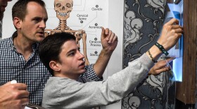 Two  people completing a puzzle in an escape Room