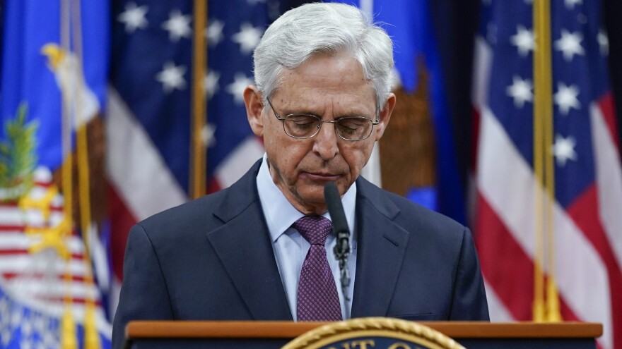 Attorney General Merrick Garland pauses as he speaks at the Department of Justice in Washington on Wednesday, in advance of the one year anniversary of the attack on the U.S. Capitol.