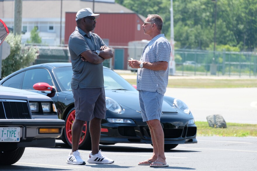DiLorenzo, right, talks with Ron Baisden, an independent voter from Portsmouth, during a 'Cars and Coffee' event in Portsmouth on August 1, 2026.