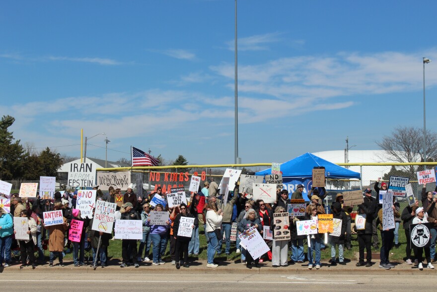 Along War Memorial Drive near Peoria Stadium demonstrators hold signs and protest the Trump administration. 