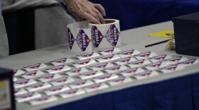 A poll worker lays out I Voted stickers at a polling place Tuesday, Nov. 8, 2022, in Las Vegas. 