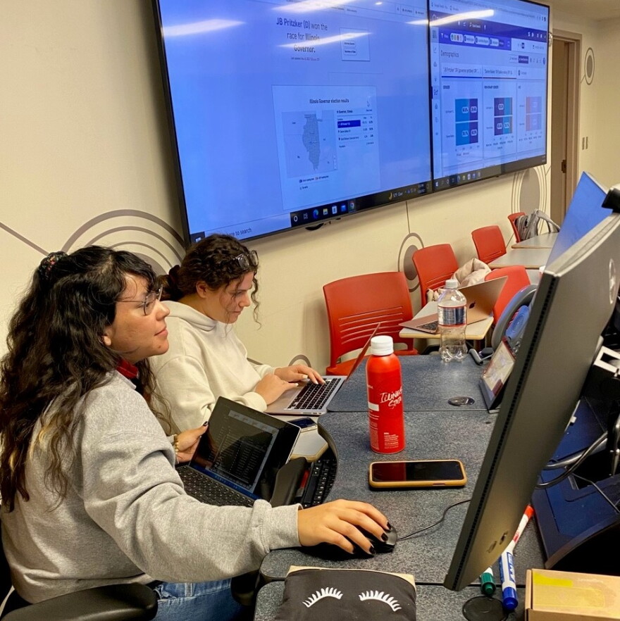 Senior journalism and political science major Yasmin Carrillo (left) and ISU grad student Mary Valentine track election results and social media trends in university’s Social Media Analytics Command Center at ISU.
