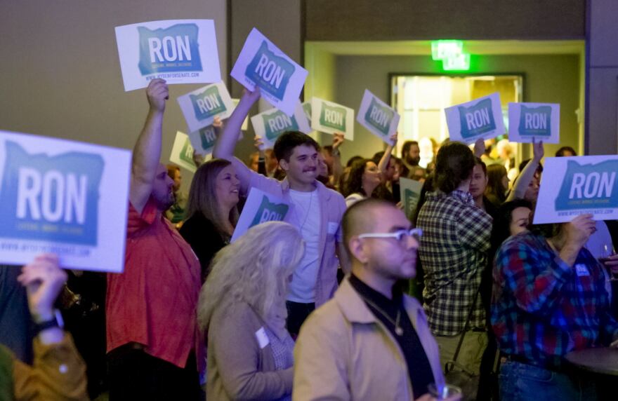 Supporters at the Democratic Party of Oregon’s election night event hold signs to celebrate U.S. Senator Ron Wyden’s win, Nov. 8, 2022 at the Hyatt Regency Portland at the Convention Center.