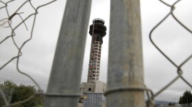 A fence secures the perimeter of a half-completed 236-foot FAA control tower at Oakland International Airport. Construction has been halted because of the FAA shutdown.