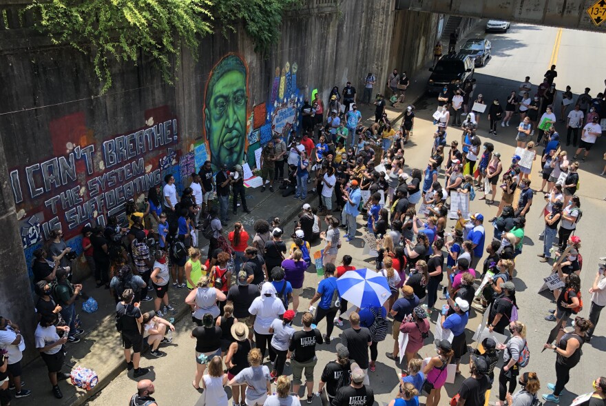 A crowd of mostly young people and educators gathered Friday at a mural on West 7th Street in Little Rock, which has had the face of George Floyd added across from civil rights leaders and symbols of peace.