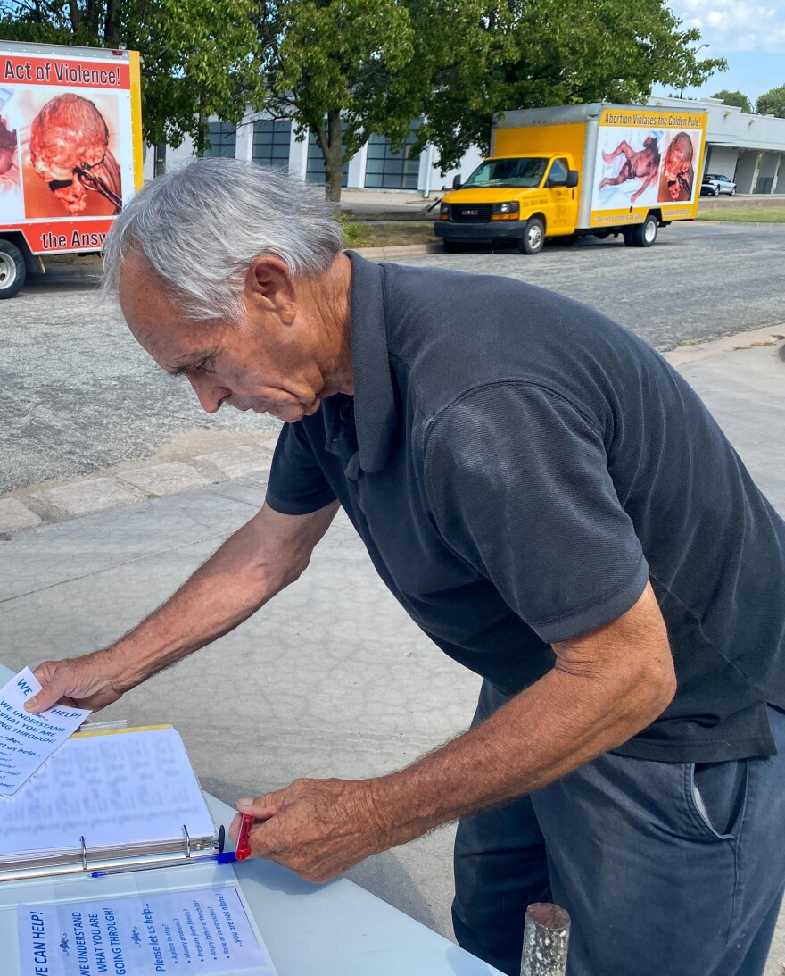 Anti-abortion protestor Mike Hagan records the license plates of cars entering Trust Women.