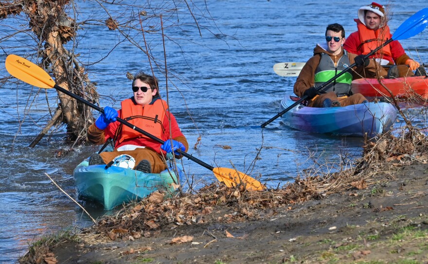 A group of kayakers, dressed as beavers, paddle into Sweeney's Beach during the Lackawanna River Conservation Association's ShiverFest on Saturday, Jan. 13.