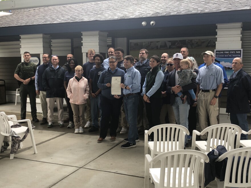 Representative Kerri Harris presents the park with a resolution on behalf of the general assembly. Harris says that before her mother passed, the two would frequent Killens Pond for hikes.