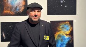 Central Florida Astronomical Society’s president, Frank Kane, standing in front of some of the photos from the astrophotography exhibit.