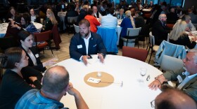 Republican gubernatorial candidate Adam Crum talks with voters at a candidate meet-and-greet in Anchorage on July 20, 2026.
