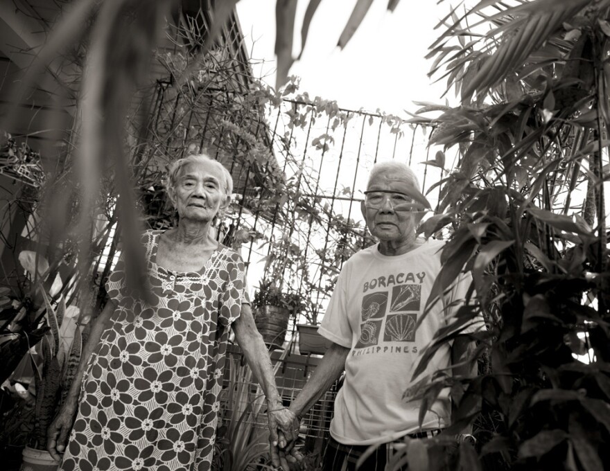 Narcisa Claveria holds hands with her husband, Anaceto. She was 12 in 1943 when Japanese soldiers came to their village in Abra. She was forced to become a sex slave, as were her two sisters. One later lost her mind; the other never came home. Claveria cared for the surviving sibling until her death.