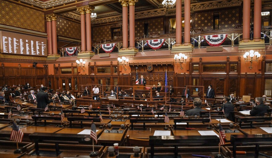 Speaker of the House Matt Ritter, D-Hartford, speaks in a mostly empty legislative chamber due to pandemic protocols, during opening session at the State Capitol, Jan. 6, 2021, in Hartford.