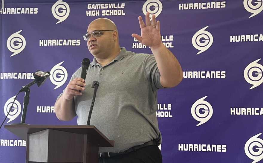 Newly-hired GHS head football coach Ian Scott speaks to the crowd during his introductory press conference on Thursday. “So excited to be able to work with all the young people here and really bring the community right into what it means to be a Hurricane,” Scott said. (Cam Parker/WUFT News)