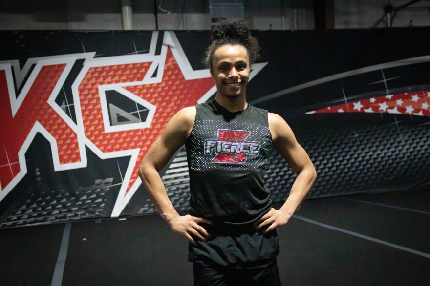 A cheerleader poses for a photo.