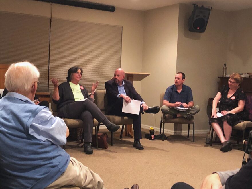 Santa Fe College professors Kate Murray, Glynn Hayes and Kim Feigenbaum discuss the economic challenges adjunct professors face during a panel sponsored by the Alachua County Labor Coalition on Tuesday night. (Camille Graham/WUFT News)