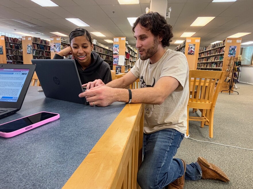 Adam Howard helps Mallory Brave, the first in her family to pursue college, with an essay for her application. Howard was the associate director of Educational Talent Search in New Hampshire until the Trump administration abruptly cut its finding, citing diversity initiates it had to include for its grant application. Now Howard helps his students for free.
