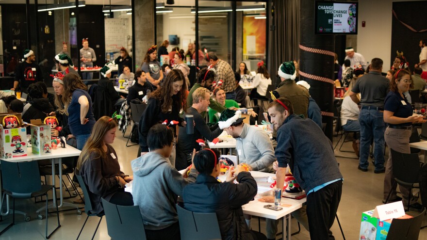 people at tables with toys