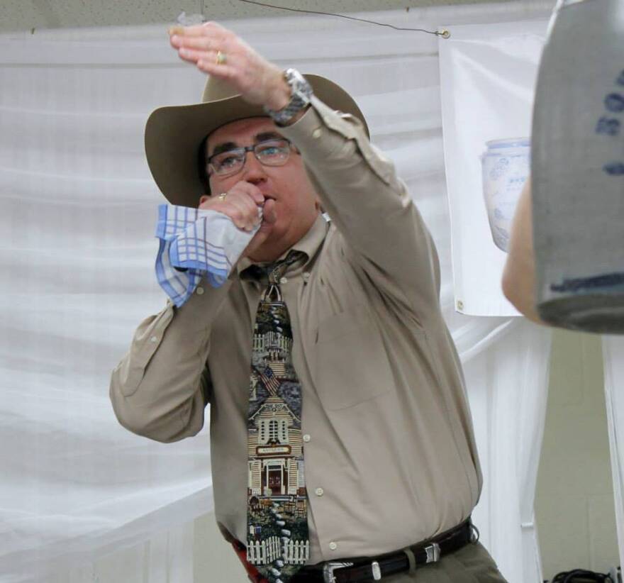 West Virginia auctioneer Joe R. Pyle in the midst of an auction - with his microphone and trademark cowboy hat.