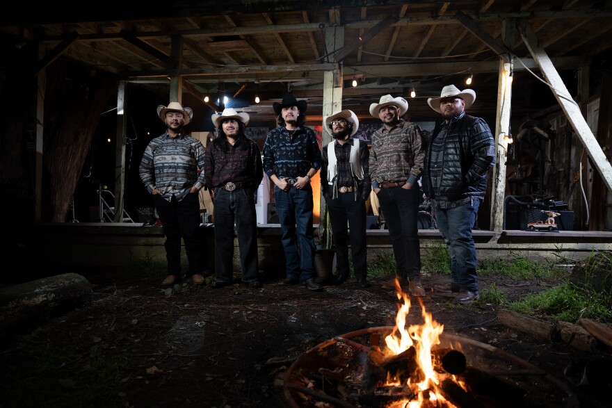 Flaco El Jandro with his band Los Perros Callejeros, who perform on the "Cobarde" song and in the tiny desk contest video
