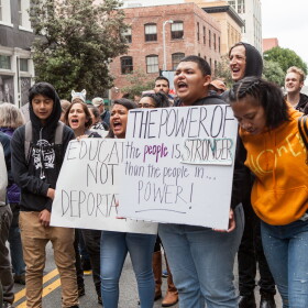 Protesters chant while holding various signs at a rally against Immigration and Customs Enforcement (ICE) in San Francisco.