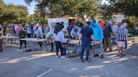 Dozens of volunteer carpenters set up shop in the parking lot of the Prime Meridian Bank on Timberlane Road.