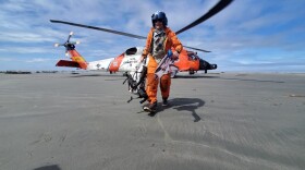 Coast Guard helicopter drops off Kodiak Island Search and Rescue Team member dropped off on beach of Tugidak Island