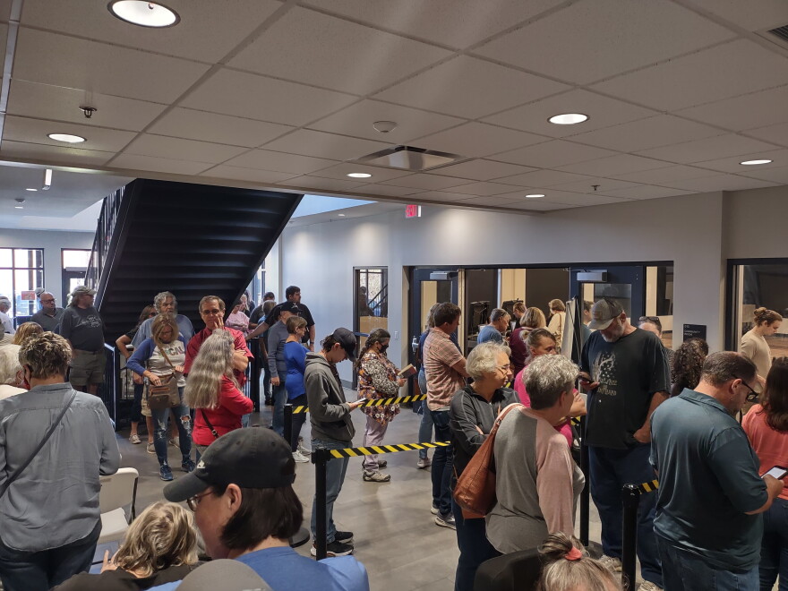 Madison County voters line up to cast early ballots at the Madison County Public Library voting center.