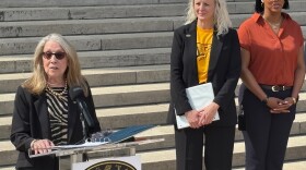 Little Rock Central High School Principal Nancy Rousseau speaks on the school's front steps on Friday, March 6, 2026, as her recommended successor April Rike (center) and Shana Spriggs-Loring (right), the Little Rock School District's Assistant Superintendent for High School Transformation and Postsecondary Readiness, look on.