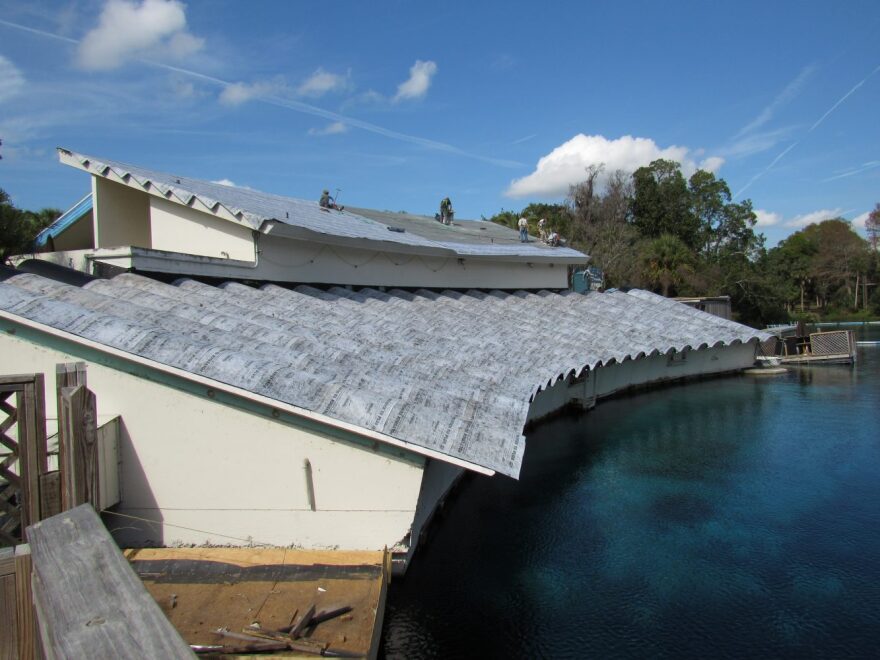 Workers restore the roof on the Newton Perry Underwater Theatre at Weeki Wachee Springs State Park on January 22, 2015. A temporary protective covering is on top of the roof to protect the theater from rain.