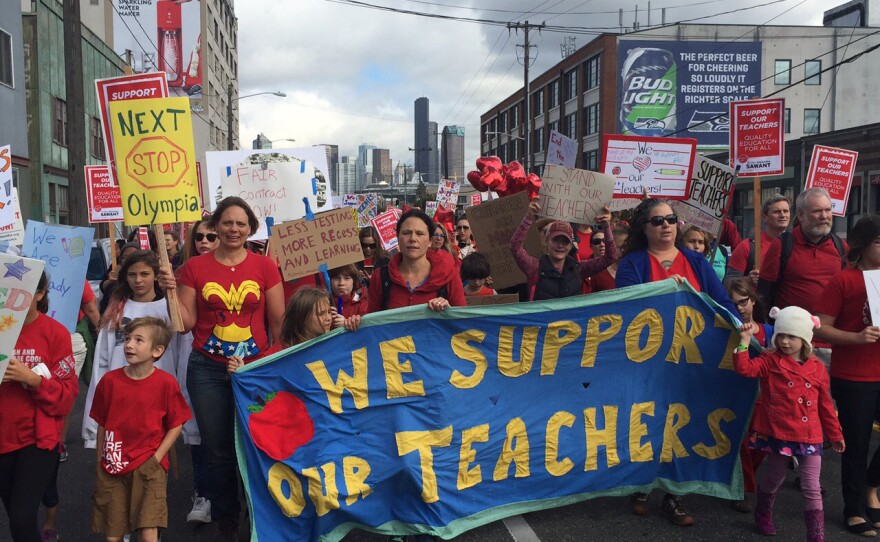 Teachers and supporters march down First Avenue South on their way to the Seattle Public Schools headquarters south of downtown on Tuesday.