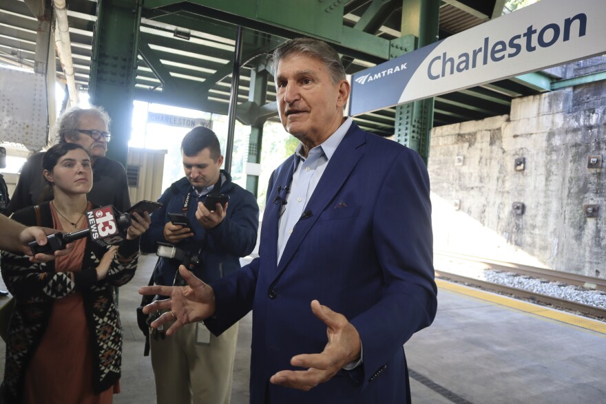 West Virginia Democratic Sen. Joe Manchin speaks with reporters outside the newly renovated Amtrak train station in Charleston, W.Va. on Thursday, Oct. 12, 2023.