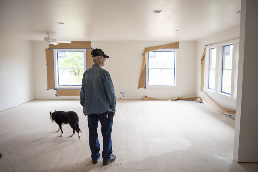 Francis Dairy examines his rebuilt home in Gates, Ore. He and his wife hope to move back in on Sept. 1. Months after the couple applied for FEMA aid, the agency encouraged people who had been denied — like the Dairys — to appeal the decisions.