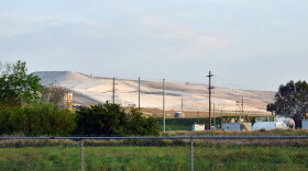 A Mosaic phosphogypsum stack stands behind a fence in Bartow, Fla. on Friday, Feb. 24, 2023.