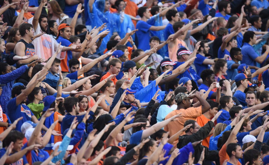 After a penalty is called against East Carolina, Florida fans do the Gator chomp and chant.