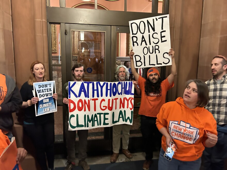 Protesters outside New York Gov. Kathy Hochul's office on March 25, 2026, in Albany urged her to back off her push to rollback regulations in the state's climate law.