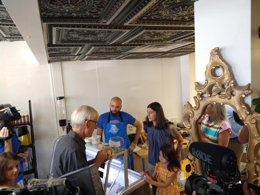 Wisconsin Gov. Tony Evers eats ice cream, while campaigning at Everyone's Ice Cream shop in West Allis Monday.