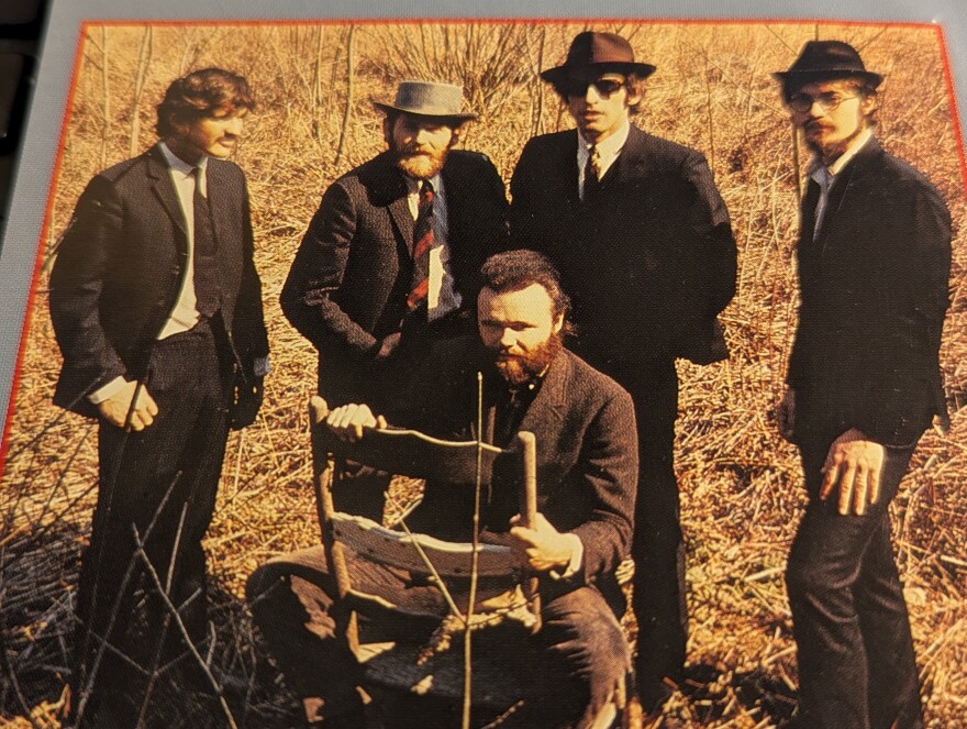 A sepia photo of five men posing.