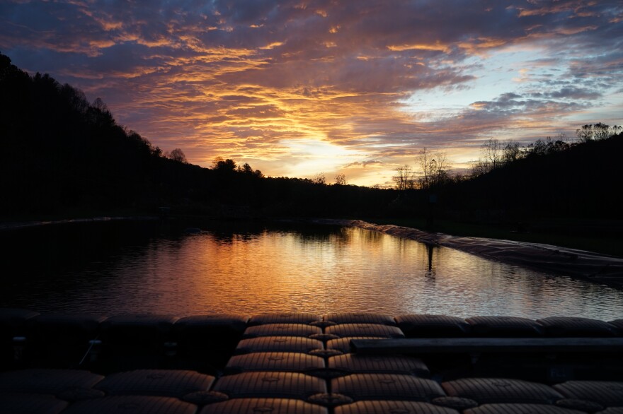 The sun sets over a pool of water at Virginia Department of Game and Inland Fisheries' freshwater mussel hatchery. More mature mussels are being raised in these exposed waters.