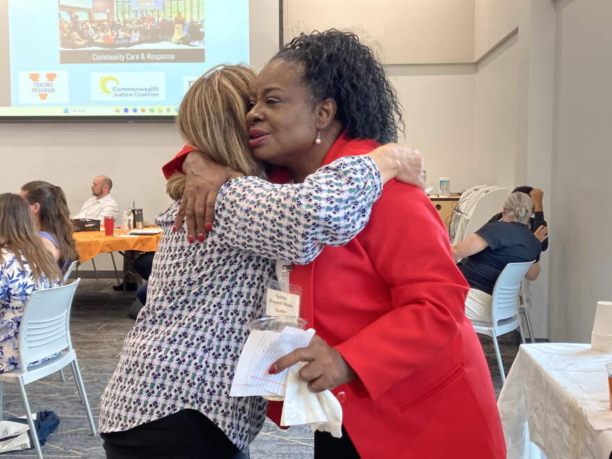 Sylvia Bennett-Stone, founder of Voices of Black Mothers United, embraces a well-wisher at UVA's third annual Gun Violence Prevention Summit.