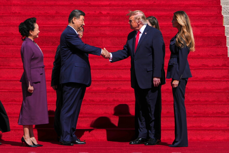 President Donald Trump, center right, shakes the hand of China's President Xi Jinping as first lady Melania Trump, right, and China's first lady Peng Liyuan, left, watch as they arrive at the National Archives Museum, Friday, Sept. 25, 2026, in Washington.