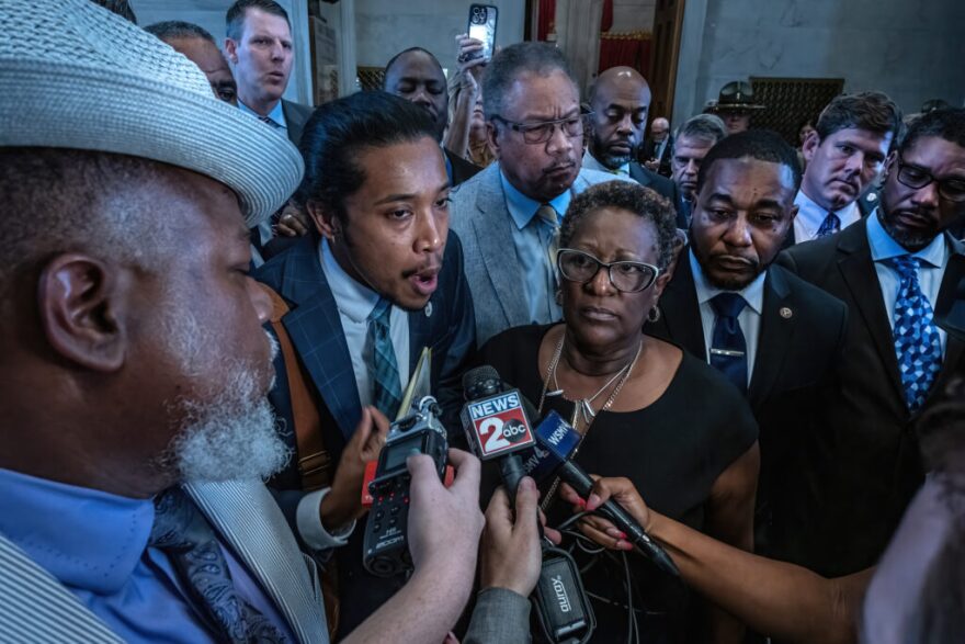 Democratic Rep. Justin Jones of Nashville, backed by members of the House Democratic Caucus, talks to members of members media after House Republicans voted to silence him on Monday. The entire Democratic Caucus walked out with Jones in solidarity.