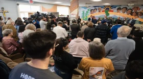 A crowd gathers a press conference at Annunciation House in El Paso on Feb. 23, 2024. Texas Attorney General Ken Paxton sued the migrant shelter, accusing it of operating a stash house and human trafficking. A judge on Tuesday ruled in favor of Annunciation House, which has been providing aid and shelter to migrants in El Paso for decades.