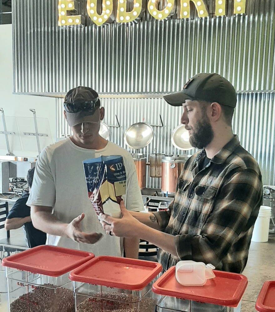 Eudora Brew Technician guides customer through brewing process.