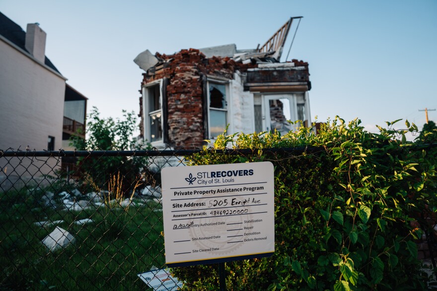 An STL Recovers sign in front of a tornado-damaged home on Enright Avenue in St. Louis on May 4