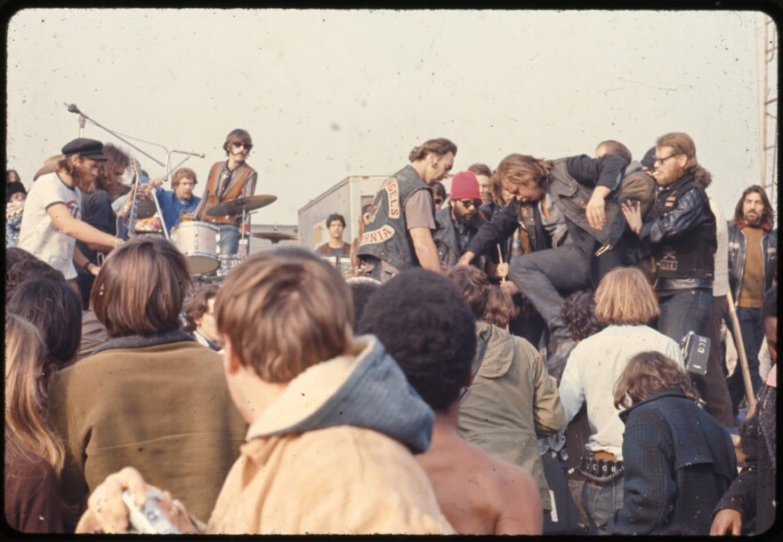 A Hells Angel stomps on an attendee at the Altamont Free Concert at Altamont Speedway in northern California on Dec. 6, 1969. (Courtesy of Beth Bagby)