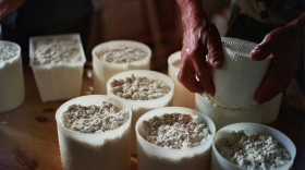 A few bowls of flour sit out on a table.