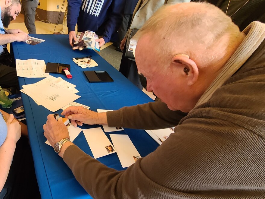 man puts postmark on an envelope