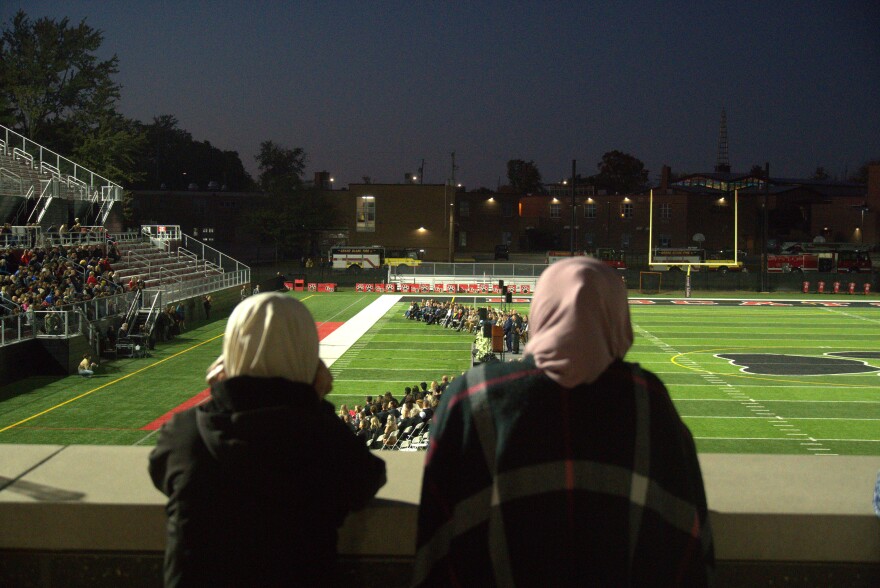Two Muslim women join the community at the memorial to mourn those lost at the Church of Latter-day Saints shooting.