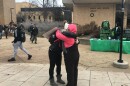 Carrie Miller (right), a member of the Rolla Mom Huggers group, hugs a student in front of the library at Missouri S&T on Dec 3, 2018.